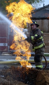 Monday November 12 2007 in Chico, CA. On Glenshire near Mariposa a home under construction had it's gas line catch on fire.City of Chico Firefighter Wes Metroka stood by with a firehose protecting a near by home until PG&E could shut off the gas.  . in this picture, (Ty Barbour/Chico Enterprise-Record)